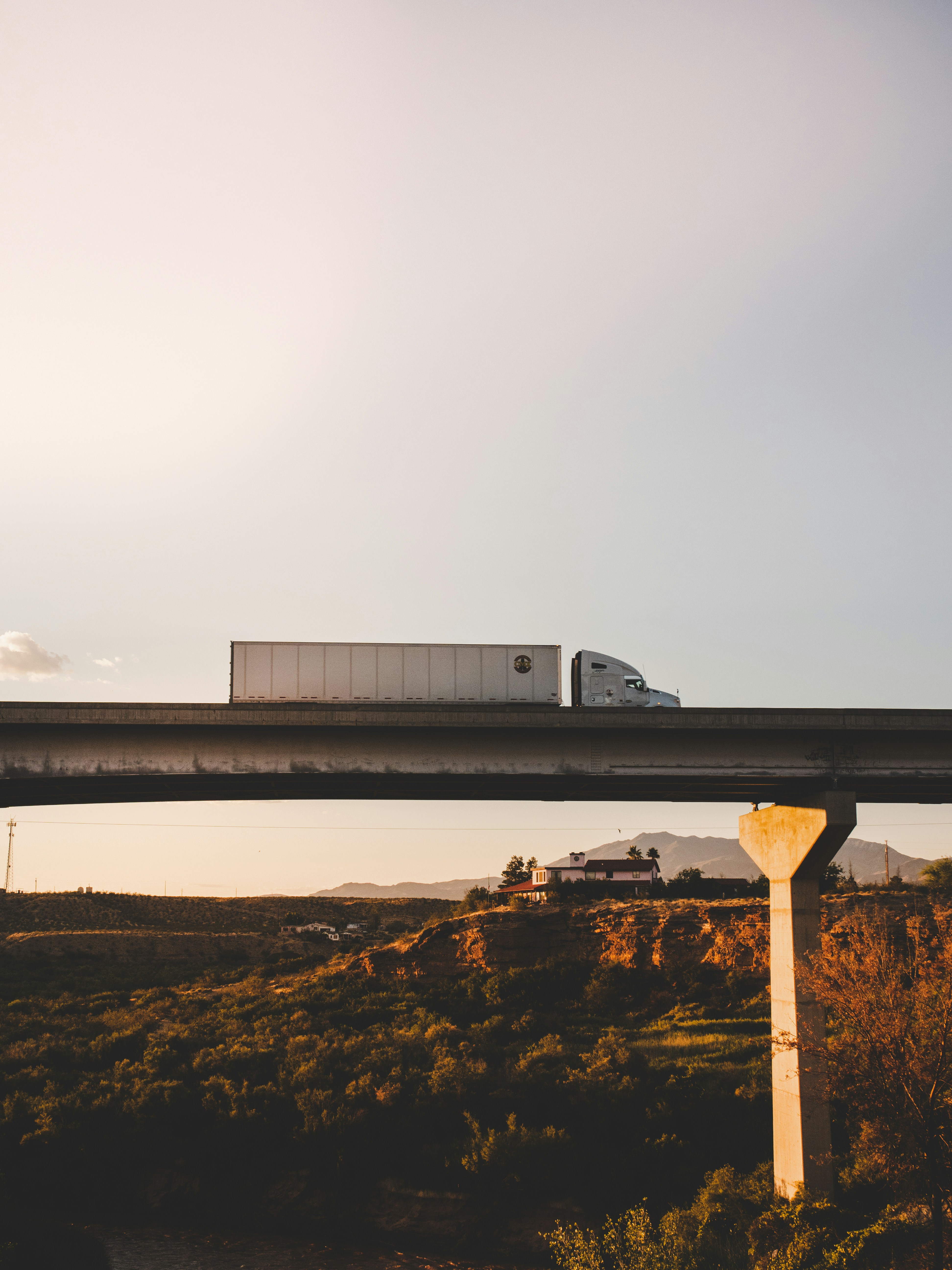Freight truck on an overpass at sunset